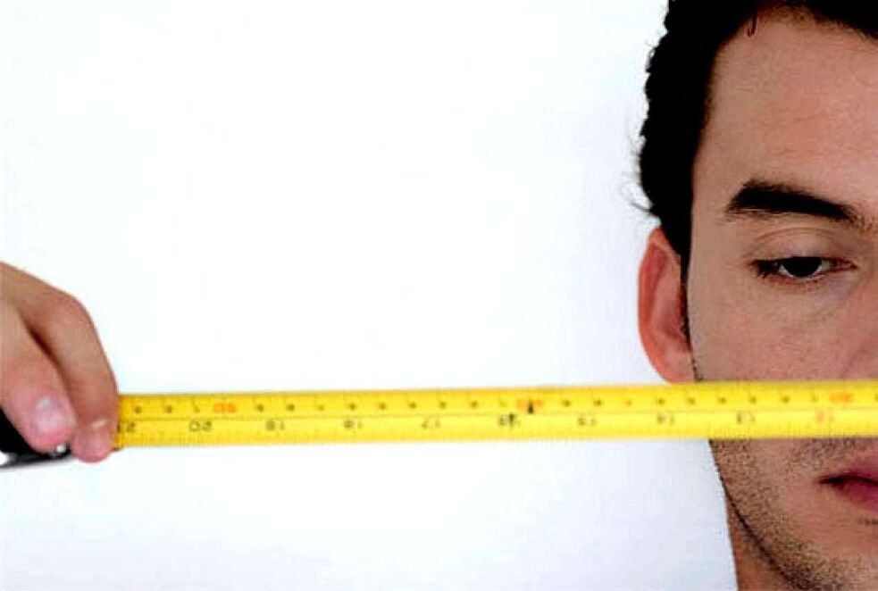 一个有尺子的男人在扩大阴茎之前测量它